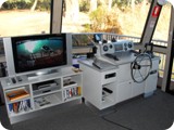 The steering console and TV with a selection of DVD's